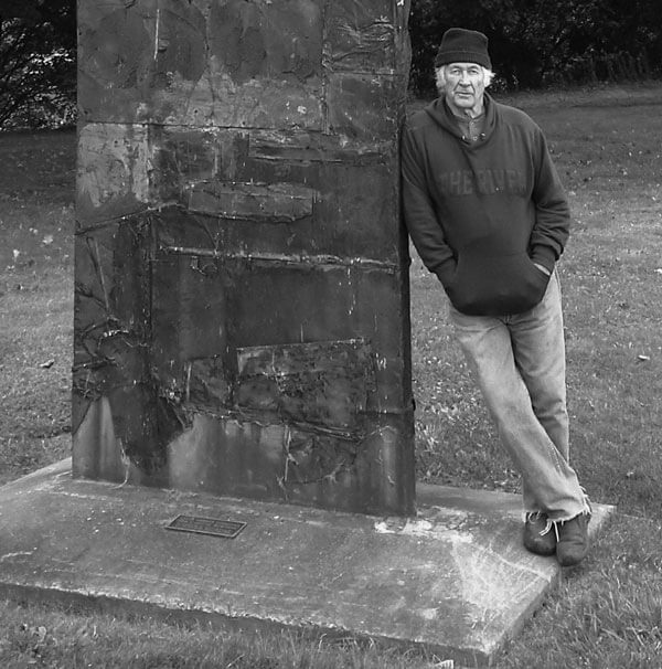 Bruce Sodervick stands against his sculpture.