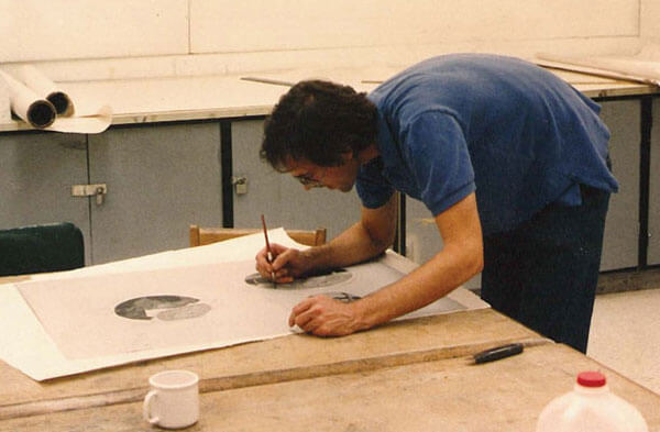 Artist David Wojnarowicz works on a drawing at the Normal Editions Workshop in 1990.