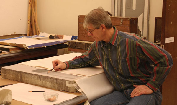 Jim Butler drawing on a lithography stone.
