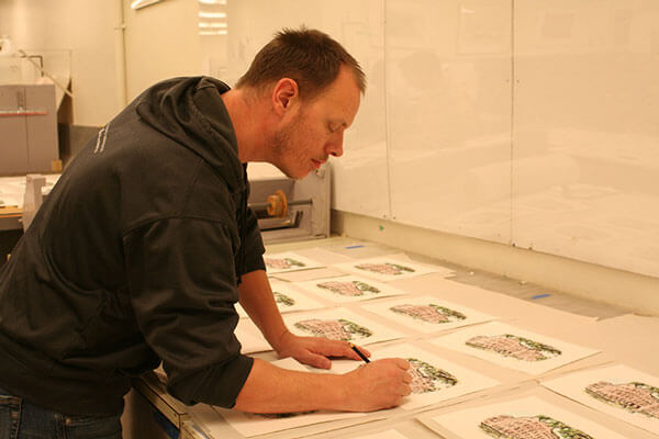 Artist John Perry signing prints