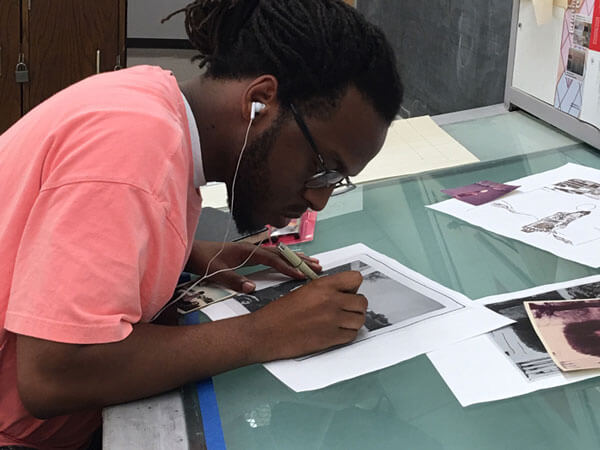 Artist Marquise Gibbs works on a print at the 40th anniversary Normal Editions Workshop.