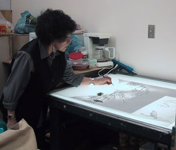 Artist Phyllis Bramson draws her print on an illuminated table.